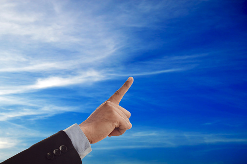 Hand of businessman - pointing towards sky - symbol success