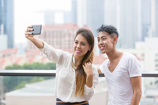 istock Young Asian Casual Couple Skyline Selfie 468899222