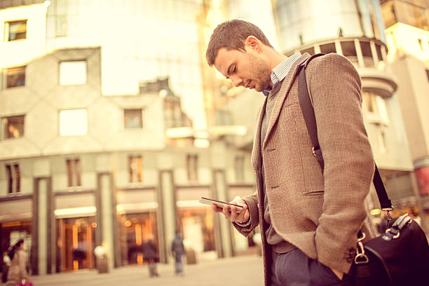istock Young man using a smarphone on the street 468899343