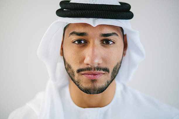 Portrait of Middle Eastern Man Close up portrait of Emirati businessman wearing traditional clothing - kandura, kaffiyeh and agal. Also known as disdasha. united arab emirates photos stock pictures, royalty-free photos & images