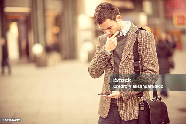 Young Man Using A Smarphone On The Street Stock Photo - Download Image Now - 25-29 Years, Adult, Adults Only