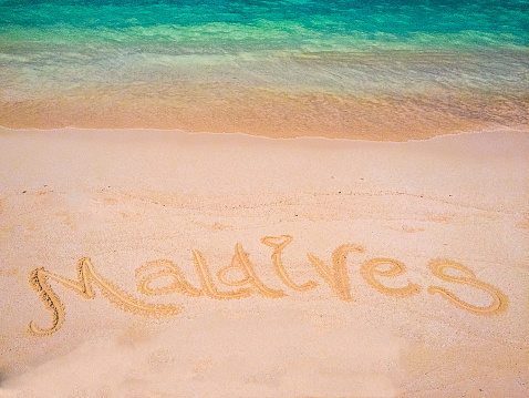 Message written in the white sand of a beautiful tropical island of Maldives // mobilestock photo, made with iPhone 5