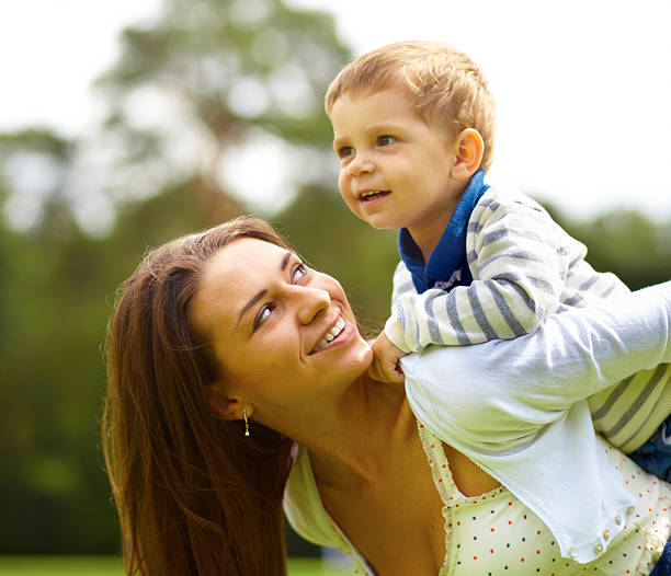 istock Woman and young boy outdoors embracing 468906613