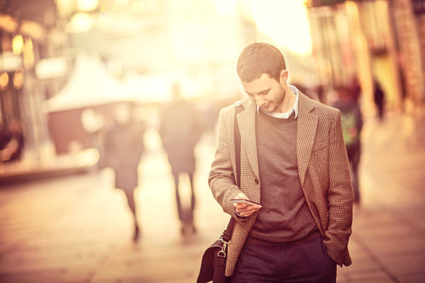 istock Young man using a smartphone on the street 468909645