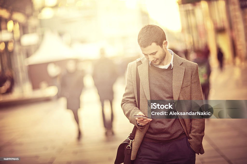 Young man using a smartphone on the street 25-29 Years Stock Photo