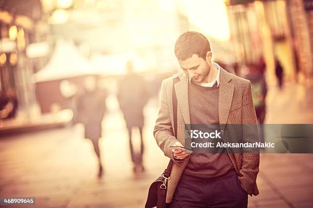 Young Man Using A Smartphone On The Street Stock Photo - Download Image Now - 25-29 Years, Adult, Adults Only