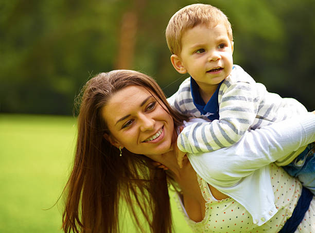istock Woman and young boy outdoors embracing 468910053