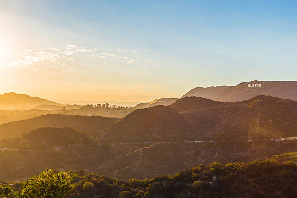Sunset over the Hollywood sign from Griffith Observatory Sunset over the Hollywood Hills showing the Hollwood sign on a beautiful evening. hollywood california stock pictures, royalty-free photos & images