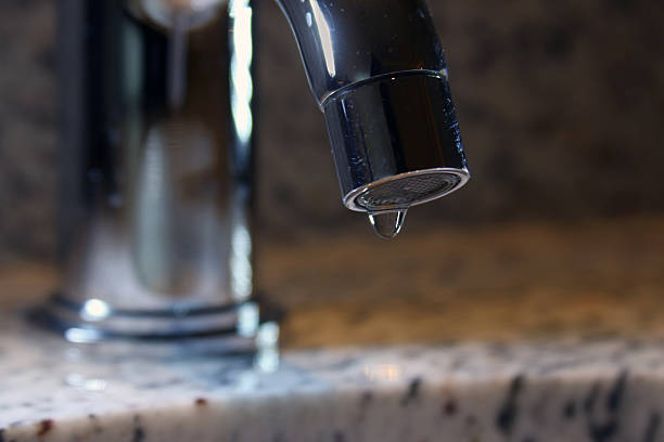 istock Dripping bathroom sink faucet 468910867