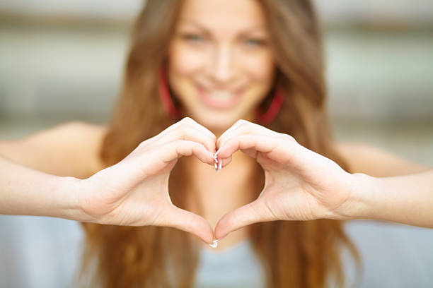 istock Young lady making a heart shape with her hands 468912597