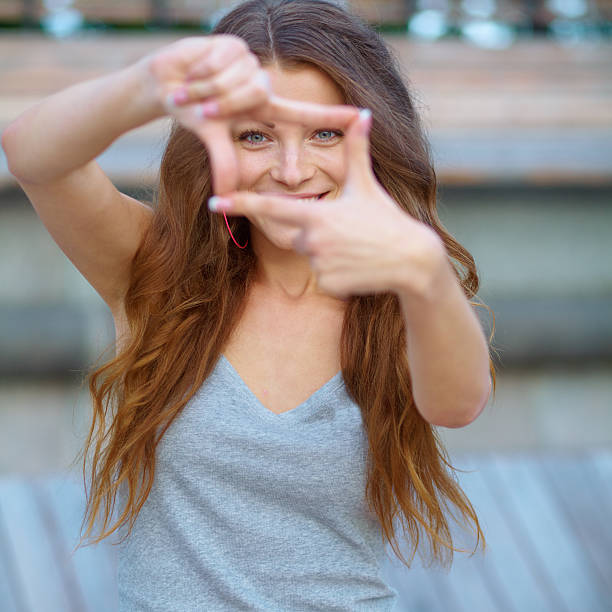 istock Closeup of young beautiful woman making frame with her hands 468912703