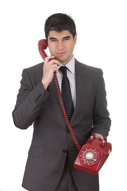 istock Businessman with a vintage red phone 468914554