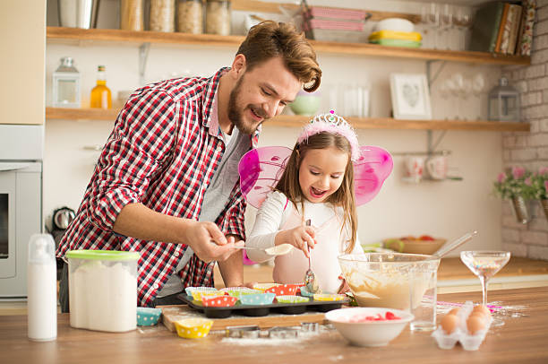 istock Father and daughter baking in kitchen. 468917328
