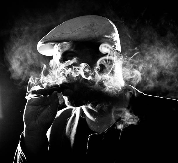 Cool man smoking cigar i the night. stock photo