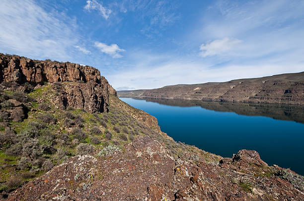 The scablands of central Washington with their rolling hillsides and basalt canyons offer some of the most colorful landscapes in the state. The Columbia River area has many such side canyons. This scene of the high bluffs overlooking the river was photographed at Ginkgo Petrified Forest State Park near Vantage, Washington State, USA.