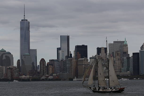 Lower Manhattan with the One World Trade Center New York, USA - October 09, 2014: Skyline of Lower Manhattan with the One World Trade Center, New York City, USA. In front a sailboat is cruising at the Hudson River. großunternehmen stock pictures, royalty-free photos & images