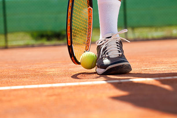 istock Leg with ball and tennis racket 468918989