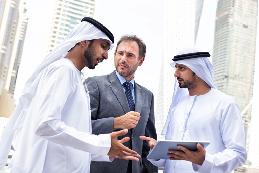 Middle eastern businessmen meeting western man. iStockalypse Dubai - UAE 2015