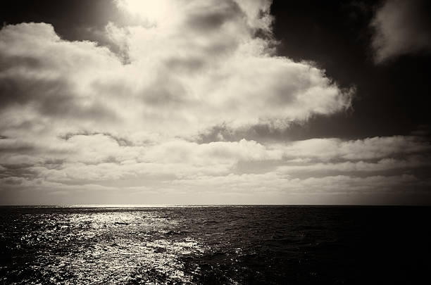 istock Sea and sun on dark cloudy sky 468922012