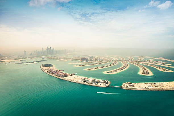 Dubai Marina skyscrapers and The Palm Island aerial view Skyscrapers of Dubai Marina and Internet City seen from an aerial view during a sunny day. In the image is visible a section of the Jumeirah Palm artificial island with luxury apartments and resorts. dubai island stock pictures, royalty-free photos & images