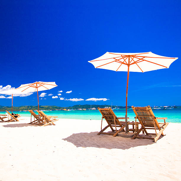 istock Chairs on exotic tropical white sandy beach 468925373