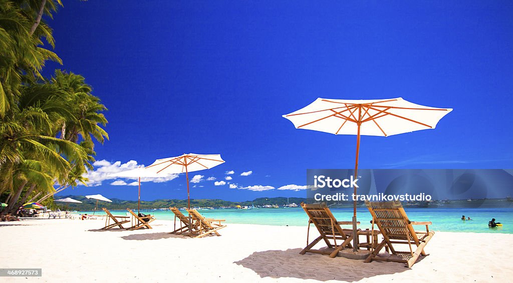 Paradise view of nice tropical empty sandy plage Paradise view of nice tropical empty sandy plage with umbrella and beach chair Boracay Stock Photo