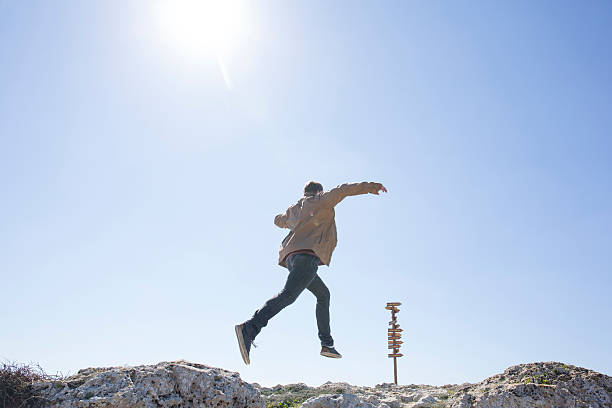 istock Young man bounds toward distant signpost 468931654