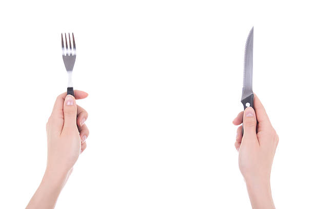 istock female hands with fork and knife isolated on white 468931950