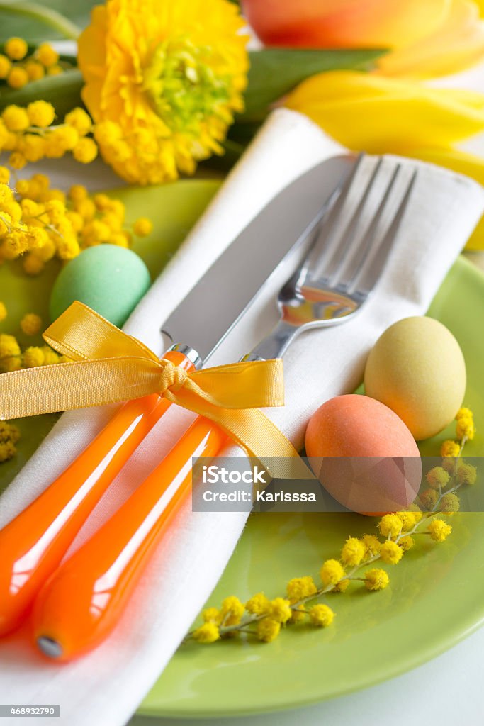 Easter table setting Easter table setting with yellow flowers and eggs 2015 Stock Photo