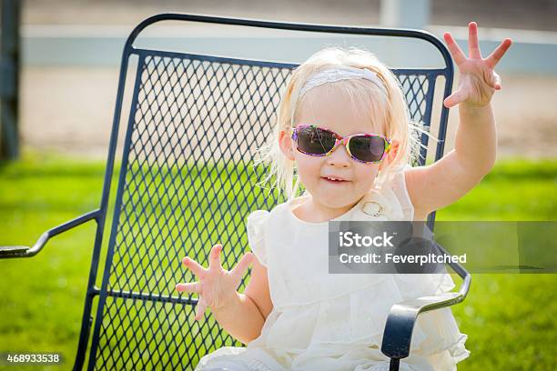 Cute Playful Baby Girl Wearing Sunglasses Outside At Park Stock Photo - Download Image Now