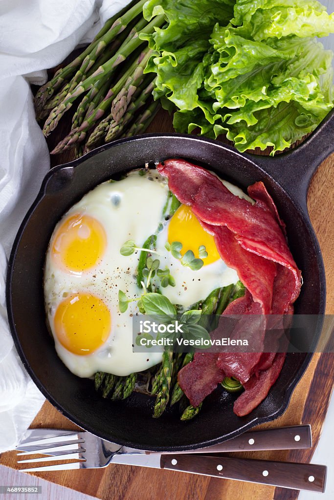 Baked eggs with asparagus and bacon Baked eggs with asparagus and turkey bacon 2015 Stock Photo