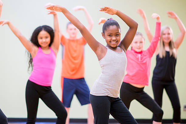 Young Children Practicing Dance A diverse group of children learning choreography in a dance class. dancing stock pictures, royalty-free photos & images