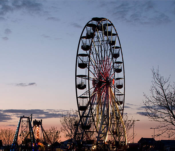 istock Sunset image of Carnival Ferris Wheel and Funfair 468936453