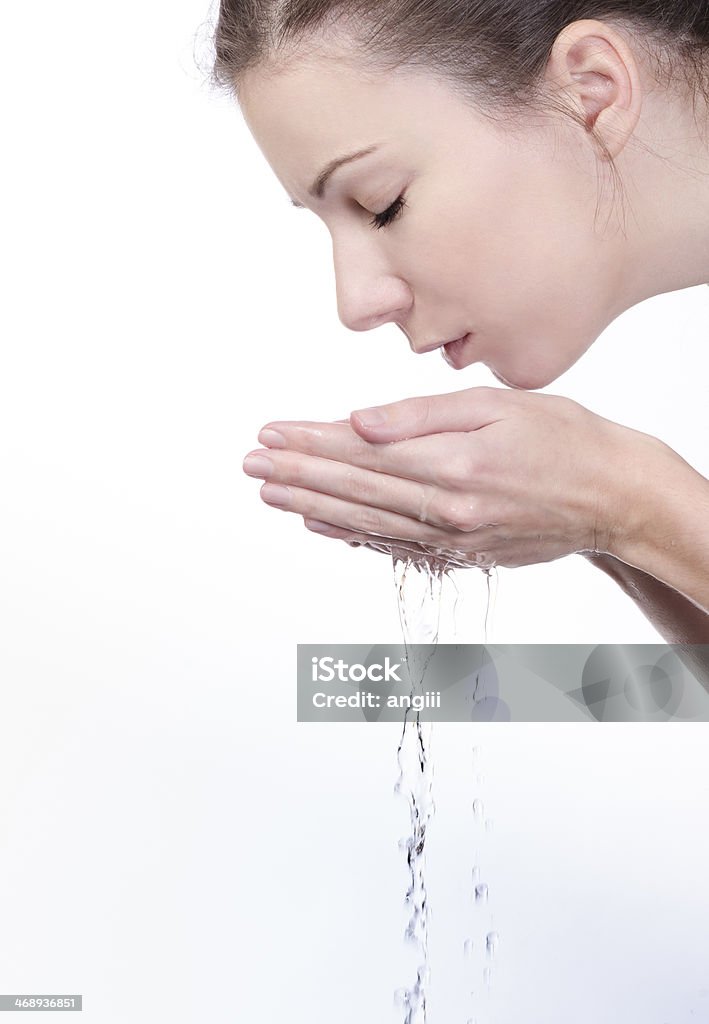 Washing face with water Washing face with water isolated on white Adult Stock Photo