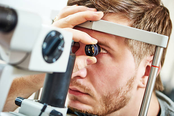 Ophthalmology eyesight examination Ophthalmology concept. Male patient under eye vision examination in eyesight ophthalmological correction clinic  dilation stock pictures, royalty-free photos & images