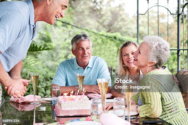 Group Of Seniors Having An Outdoors Birthday Party Stock Photo - Download Image Now - 2015, 60-69 Years, Active Seniors