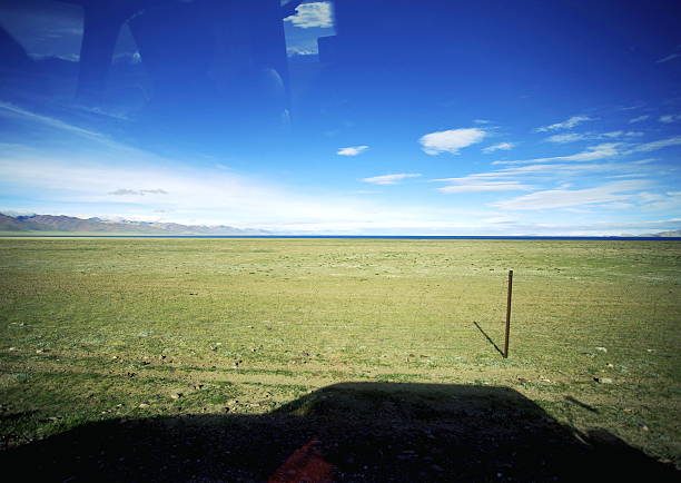 Road trip in Tibet with blue sky and grassland