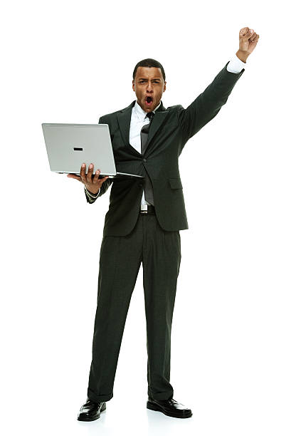 istock Excited businessman holding laptop and cheering 468942788
