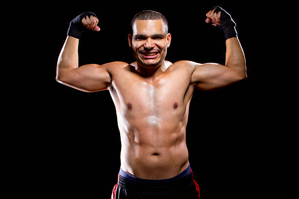 istock Fit Latin Fighter Flexing Muscles and smiling 468946966