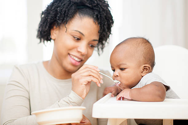 istock Young Mother Feeding Baby 468948762