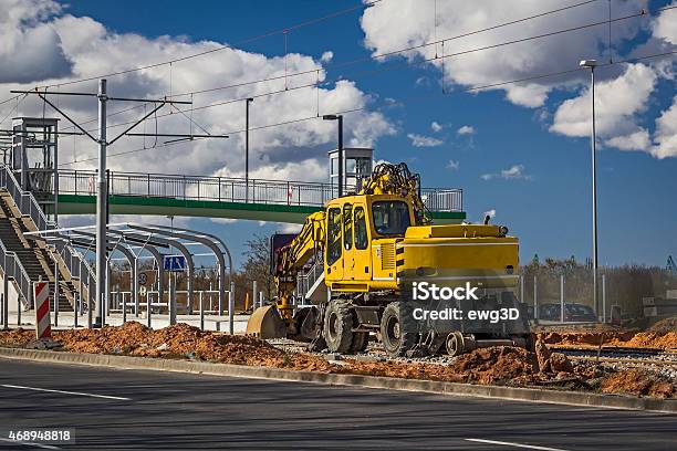 Excavator While Working On The Tram Tracks Stock Photo - Download Image Now - Backhoe, Power Line, Vehicle Scoop