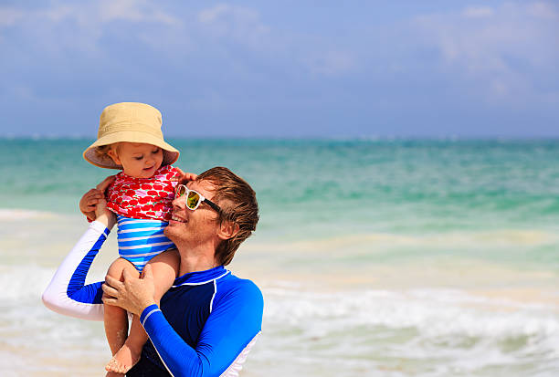 istock father and little daughter fun on the beach 468949120