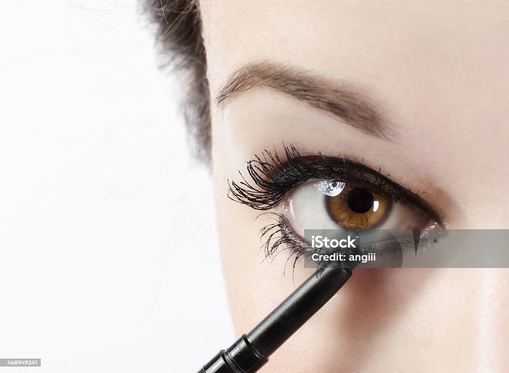 Make up Woman applying make-up with eye pencil Make-Up Stock Photo