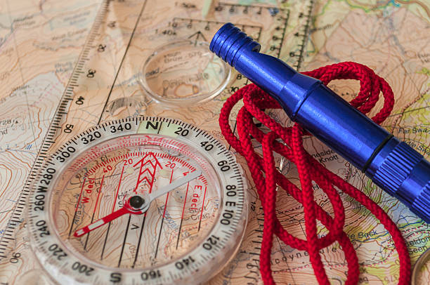 компас на карте и экстренная whistle - orienteering planning mountain climbing compass стоковые фото и изображения
