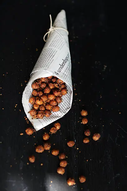 Chickpeas roasted with egyptian spices dukkah, spicy street-food wrapped in used newspaper cone