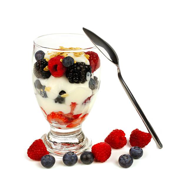 istock Mixed berry, granola and yogurt parfait with spoon over white 468956910