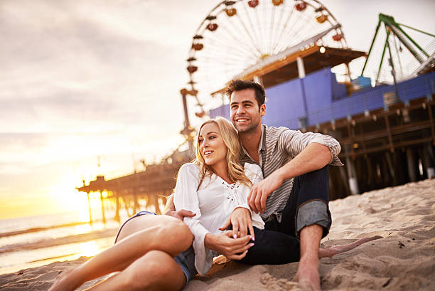 istock happy romantic couple at santa monica during sunset 468957428