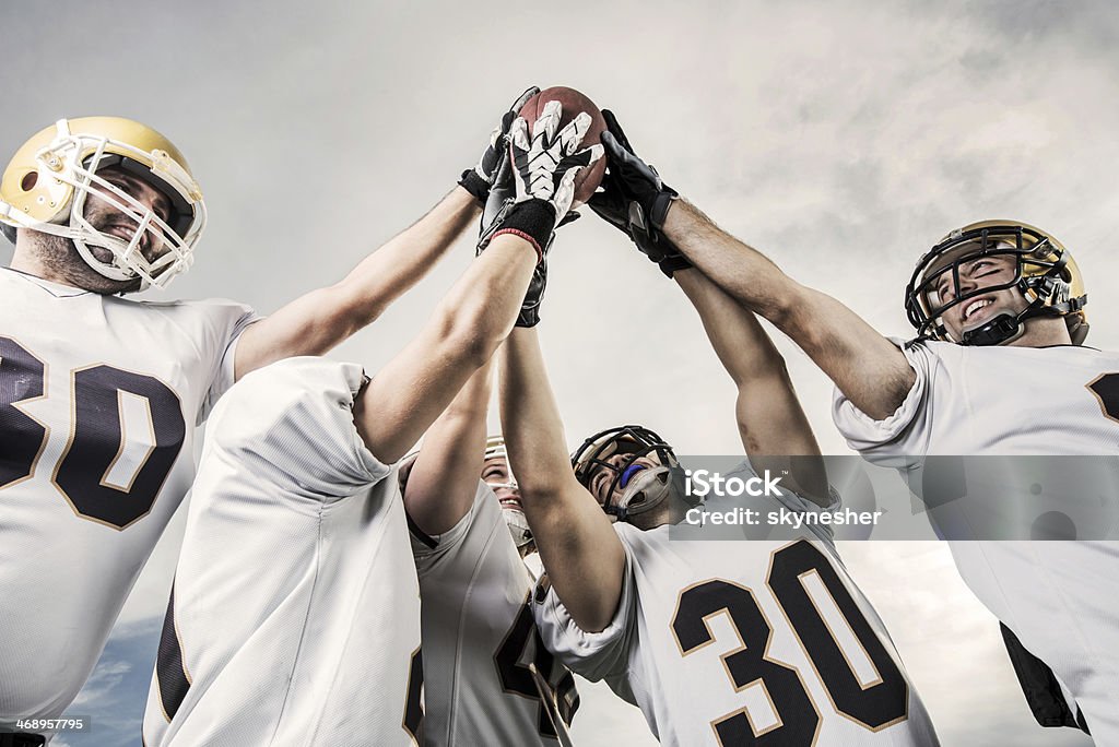 Unità di football americano di giocatori. - Foto stock royalty-free di Squadra di football americano