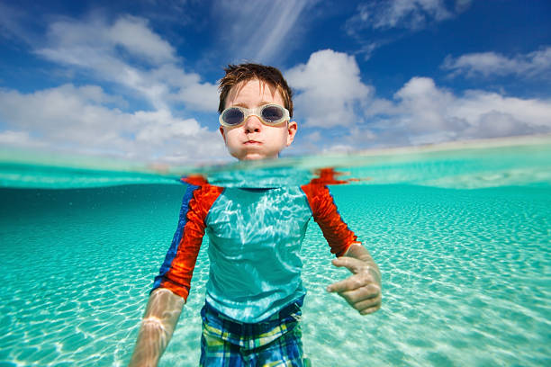 Little boy swimming in ocean