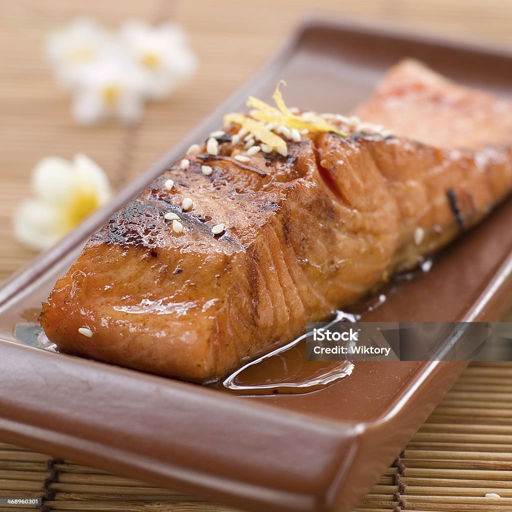 grilled salmon Grilled salmon fillet with sauce and sesame seeds, selective focus Baked Stock Photo